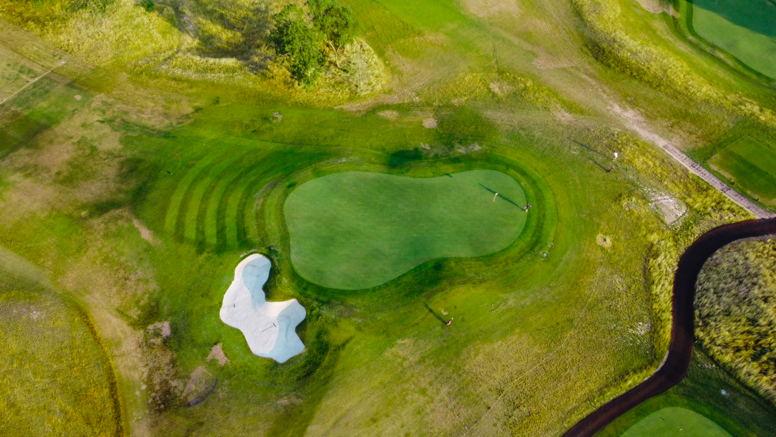 Aerial drone photography of golf course green and bunker