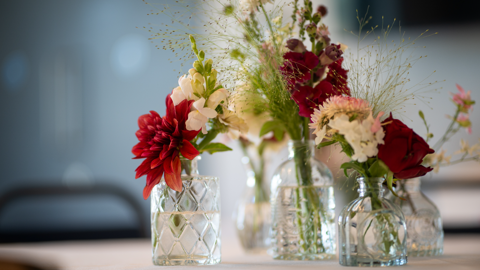 Wedding flower arrangement detail in glass vases